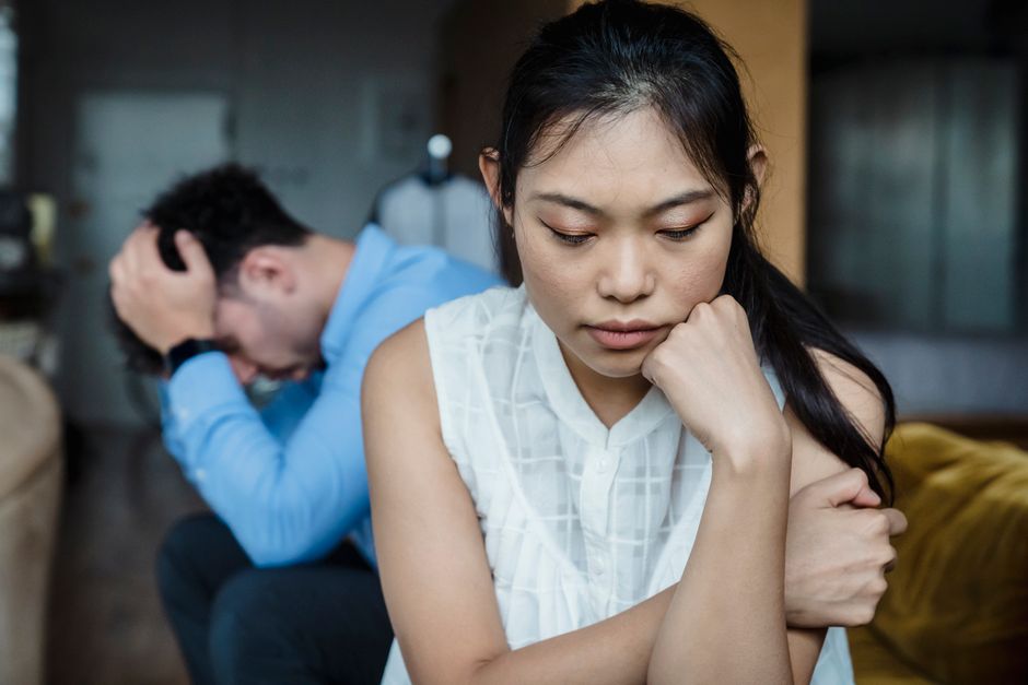 葛藤する表情の男性が家の中で思い悩んでいる様子