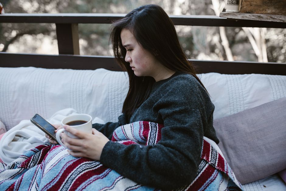 スマホを見て不安そうな表情の女性